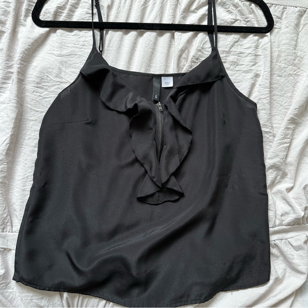 Black tank with front zip and ruffle detailing